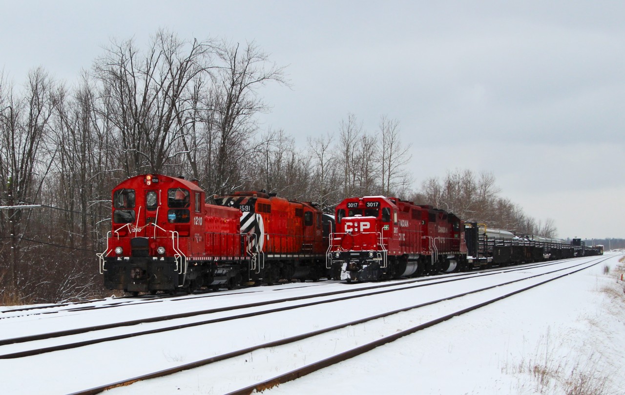 OSR 1210 along with OSR 1591 work on a switch in Guelph Junction while the track rail train, CP 3017, sits idling waiting for its crew to arrive to head west.