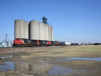 Dwarfed by the massive Wanstead Co-op grain elevator complex, CN 2547 leads a westbound freight heading towards Sarnia.