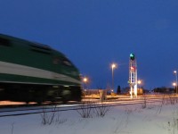 High Green at Allandale. The last southbound GO train is about to pass the newly activated signal at the north end of the Barrie yard. The number plate and signs on the signal are still covered.