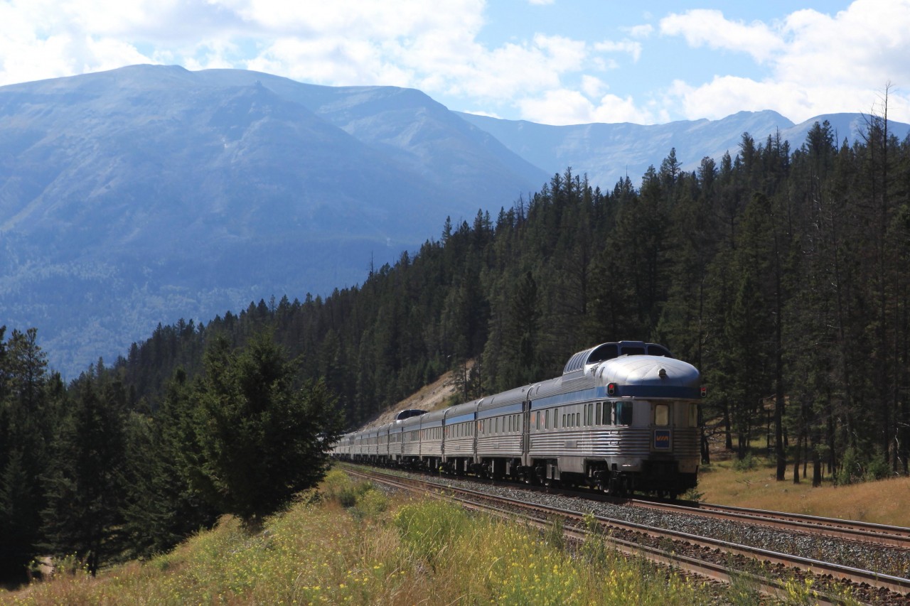 VIA Rail's westbound Canadian was pretty close to the advertised as it passed through English shortly before arrival in Jasper. Before repainting the Park cars were a fitting tale end of a train. Nowadays this thick black  line, well... In the far background Whistlers Mountain may be seen.
