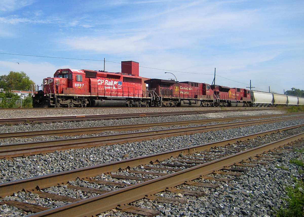 The right leader. CP 5907, CP 9620 & CP 9132 lead a westbound through Dorval in 2008. In the foreground are four tracks. The three closest are part of CN's Montreal sub, which will become CN's Kingston sub in a few hundred metres. The furthest track was the CN/CP interchange track, removed and relocated a couple of miles west about two years later.