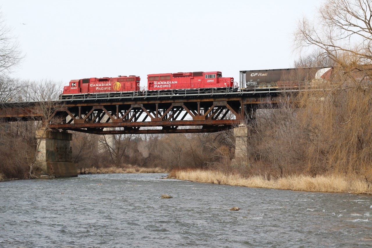 After working ADM on the south track CP T14 backs its train to Erindale. After waiting for the passage of an odd mid day GO train the local switches to the north track and heads back to Streetsville to work Ardent Mill. Ardent bought the Streetsville elevator from Mondelez (owned by Kraft) a few years ago when the that company lost a bid to expand the facility. T14 is seen here rolling over the Credit River just east of the elevator. Power today is one of CP's 21 GP38ACs recently relocated from western Canada, as well as GP20 2264.