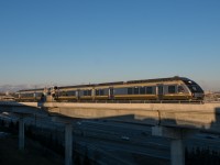 It's 17:09 on the coldest day of the winter yet and Union Pearson Express 4091 is knocking down the advance to Pearson on the west track of the Pearson Sub. 1010, 3004 and 1002 will make 6 more roundtrips before returning to either Don or Willowbrook Yard or the TMC, while the passengers onboard may find themselves thousands of miles away in warmer weather by the time that happens. Shadowed by the guideway and value park garage, traffic comes and goes. By the time this consist returns to the airport 75 minutes later, it is possible that passengers from the landing plane in the background will have made it through customs and baggage claim, ready to board the UP Express for a trip into the city.