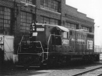 Penn Central Geep 5827 basking in the warm Sunday sunshine alongside the old Michigan Central diesel shop many years ago. Not much happening that day.