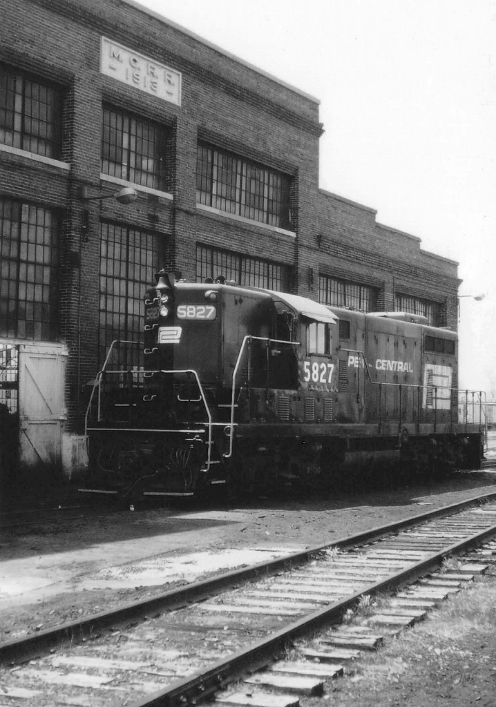 Penn Central Geep 5827 basking in the warm Sunday sunshine alongside the old Michigan Central diesel shop many years ago. Not much happening that day.