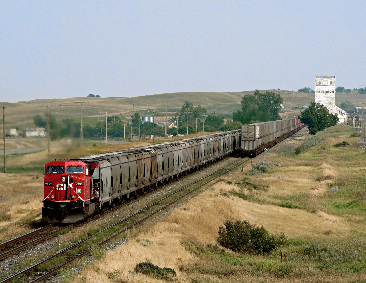 A westbound potash clears the west end of Parkbeg siding while an eastbound container train sits in the hole.
