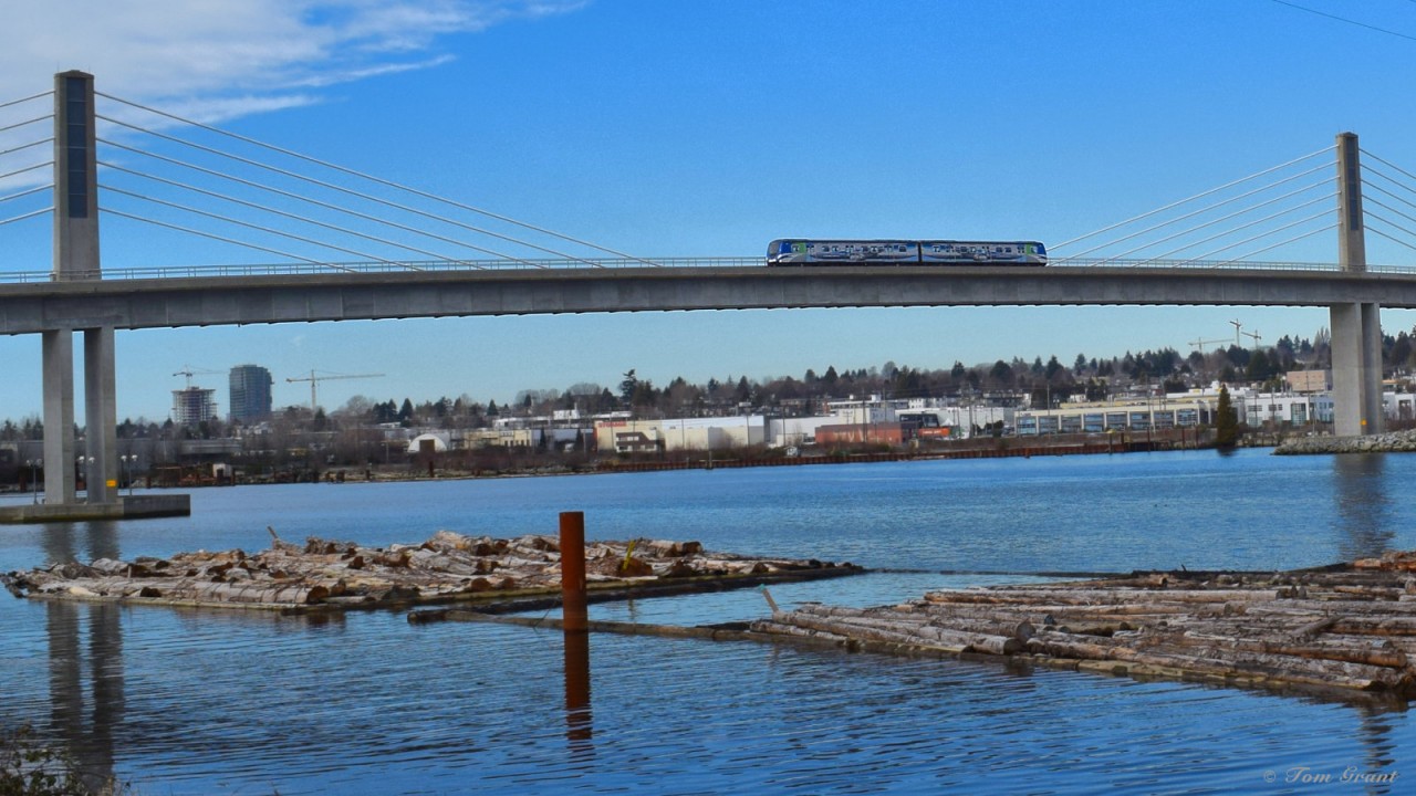 Canada Line Hyundai-Rotem on the North Arm Bridge over the North Arm Fraser River northbound into Marine Drive Station.  This is an extradosed transit/pedestrian bridge.