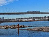 Canada Line Hyundai-Rotem on the North Arm Bridge over the North Arm Fraser River northbound into Marine Drive Station.  This is an extradosed transit/pedestrian bridge.