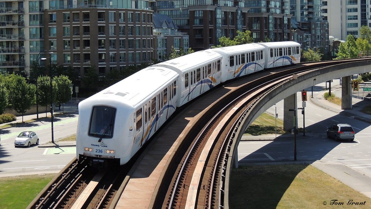 Millennium Line SkyTrain Bombardier ART MkII inbound (to camera) to Stadium/Chinatown Stn. The train has come from the Main Street/Science World Stn which upon leaving that station goes thru an office tower at about the second floor.