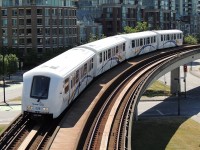 Millennium Line SkyTrain Bombardier ART MkII inbound (to camera) to Stadium/Chinatown Stn. The train has come from the Main Street/Science World Stn which upon leaving that station goes thru an office tower at about the second floor.