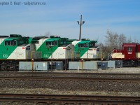 On the Guelph Junction Railway - GO Transit leased GJR property to build a yard in the late 70's, and expanded it in the 1980's - this arrangement continued until the new Milton layover yard was built, which meant as OSR took over switching GJR for a few years you could shoot an odd pairings like this.<br><br>182 was since transferred to Salford, GOT 530 to AMT then to SLC, 532 to AMT (then what? Altoona for?), GOT 557 is still on the roster and I'm sure I've shot it in the last year or two on the "L10L's that roam the system. <br><br>Also worth noting that the yard has reverted to GJR ownership, recently the east switches for the GO yard have been removed and tracks straightened/stub ended.