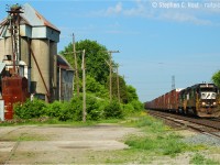 <b>While not old enough for the Time Machine, I would challenge a viewer to dig out an even older image</b> if you feel like it of course :).  In response to Joe Bishops's <a href=http://www.railpictures.ca/?attachment_id=23081 target=_blank>Copetown shot</a> posted today, I happened to be looking at this photo the other day and felt it was a timely dig-out from my 'archive'. Nearly 10 years ago we see NS 328 with SD60 6518 and High-hood SD40-2 3308 with 35 cars rolling by the Copetown feed mill, and you can easily see some of the changes over the last 10 years. If anyone has something older than this.. no complaints if you wanted to dig it out :)<br><br>Things were busy that morning. NS 328 went by at 0900. At 0904,  a CN 399 with 2444/CSXT 8115 went by on the north track. At 0913 NS 327 passed by with  NS 9146, NS 9836 and 15 cars, also on the north track. Three freights in 15 minutes, not bad. I followed 327 to Lynden (in futility, NS 327 was permitted to run at 70 MPH - "express speed' - 5 MPH faster than posted 65 MPH speed!). After missing 327 at Lynden at 0922,  CN 394 went by at 0941 with BNSF 538 leading WC 6003, CN 5605, CN 9441 and a general freight.  I spent a lot of time watching and photographing in 2006, much more than I do these days. The sheer volume of freight difference in the last 10 years is staggering. I counted 19 trains one morning to early afternoon session in 2006.. today I'd be happy with half that number.