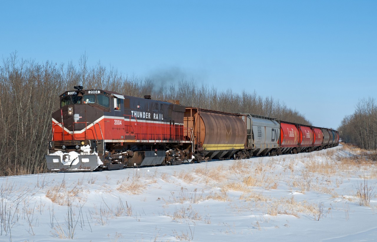 On a cold and sunny March day, is there anything better to do than chase a seldom photographed shortline in the middle of no where ?  Of course not! Thunder Rail's only unit, an MLW M420, is seen here slowly nearing Crooked River SK.