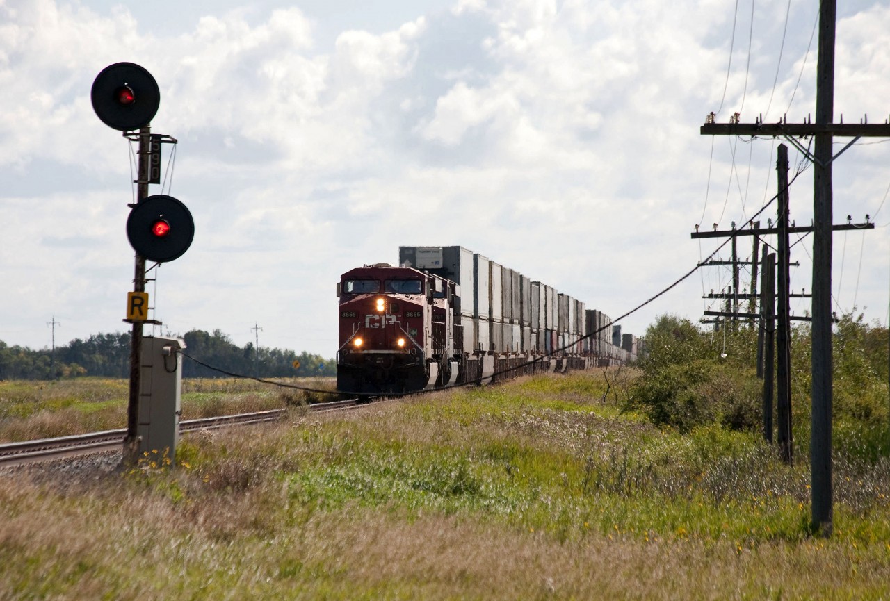 CP 113 is just about to split the signals at MP 59, 3 milkes to the west of Hargrave on the Broadview Sub.  Back-lighting is the main challenge when shooting this train in western Manitoba.