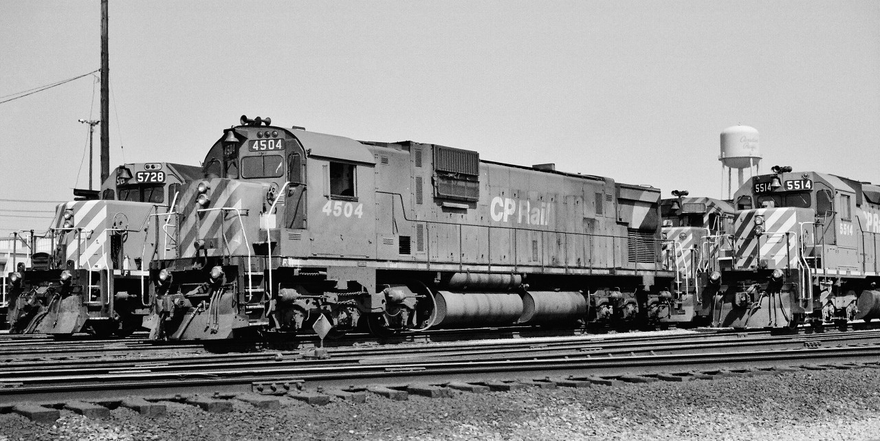 seventies road power 

  
 four models, two builders
 
  
 and three of the four were delivered to the CPR in maroon and gray livery.
 
  
 SD40-2   CP Rail 5728  (GMD September 1975) 
 
   
 C-630M  CP Rail 4504  (MLW 1968 )
 
  
 GP35  CP Rail 5021  (GMD 1965 ), the future cab-slug 1128
 
  
 SD40  CP Rail 5514  (GMD 1966 ), the future DM&E 6081
 
  
 On a warm, sunny , spring 1977 Sunday, negative by S.Danko
 
  
 What's interesting:
  
  
 the different types and locations:    classification lights,  horn,  radio antenna,  manual brake wheel / lever
 
  
 consistent location:   the bell,  dual sealed beam head lamp
 
  
  old and new versions:   CP Rail stripes
 
  
 and the one constant:   Canadian Pacific script  lettering on the Agincourt water tower
  
 
  
 CP Rail  regularly paired big six axle power with smaller four axle,( witness here the C-630M  /  GP35 lashup ). More:  
 
  
      M – F   lashup  
 
   
     M – RS   lashup  
 
   
     M – GP – M – C    lashup  
 
   
    GP – SD    lashup  
 

sdfourty