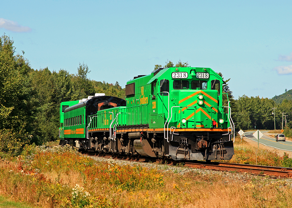 On 9/9/2009 government and railroad dignitaries got together for a photo op to commemorate a $36M investment for track and equipment (and by extension rail service) improvements in the NBSR service area. The railroad put together this sweet consist to move the VIPs back up the line a ways to observe some trackwork in progress. A big thank-you to engineer Gilles and conductor Chris for giving me the heads-up about this event while chatting with them the day before at McAdam Station, as they waited for clearance to proceed with train 908.