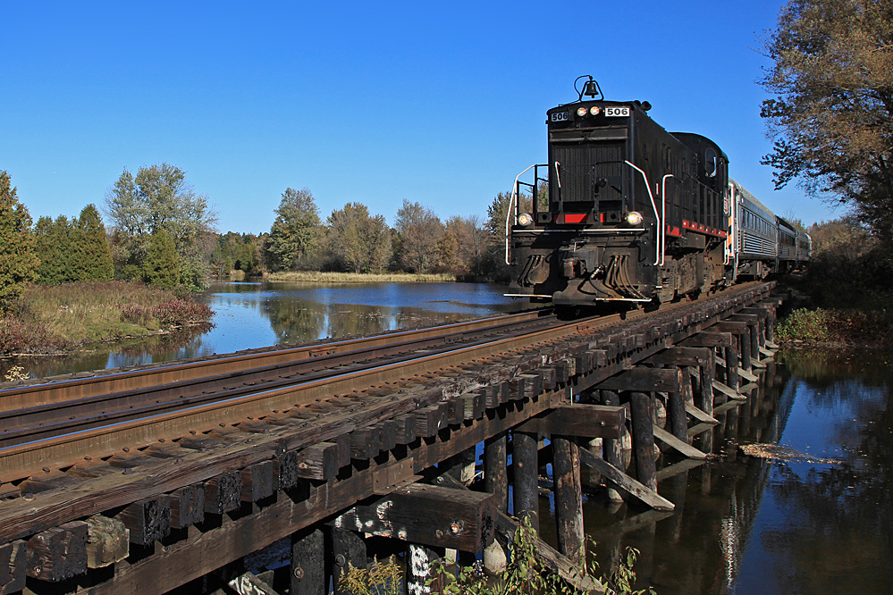 The short-lived but fondly remembered Guelph Junction Express crosses the Eramosa River as it returns to Guelph from a lunch excursion. Unfortunately the trestle no longer has it's nostalgic charm, having been propped up with more pilings and massive steel girders recently, but I suppose it was necessary.