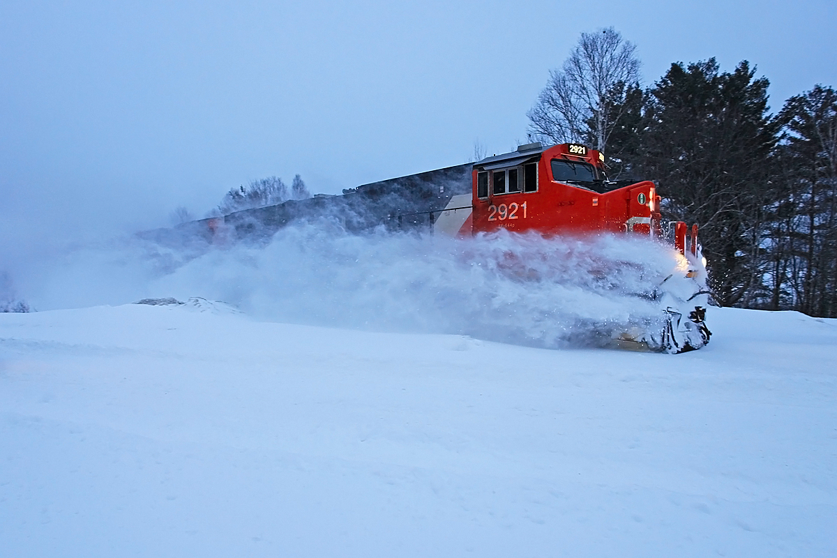 Its becoming increasingly rare to see 451 in these parts in anything resembling daylight. Here a late-runner is caught approaching the south switch at Martins in the "blue hour" just before dawn led by CN 2921 with 2920 trailing. Unfortunately the road plows hadn't been out yet so no snowbanks to bust, but at least there was enough accumulation to make for a nice trail.