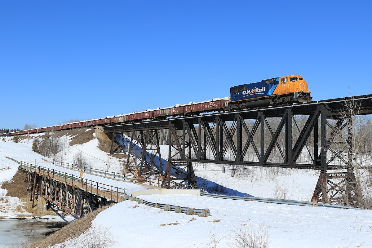 A sinlge SD70I locomotive (the typical power for this train) leads 53 cars over the bridge at Monteith.