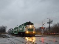 <b>In the early morning rain, L10L heading east!</b>  After receiving a heads up from Steve Host (thanks again!) of GO F59PH's on a GO train in Kitchener, I took a chance and shot the second GO train, not knowing if the F59's were on the first.  Luck was on my side, as GOT 561 and GOT 557 sandwich 10 bi-level cars in the "classic" GO paint, at Alma Street.<br><br>With the new MP54's on the way, who knows how much longer these F59's will remain in service.