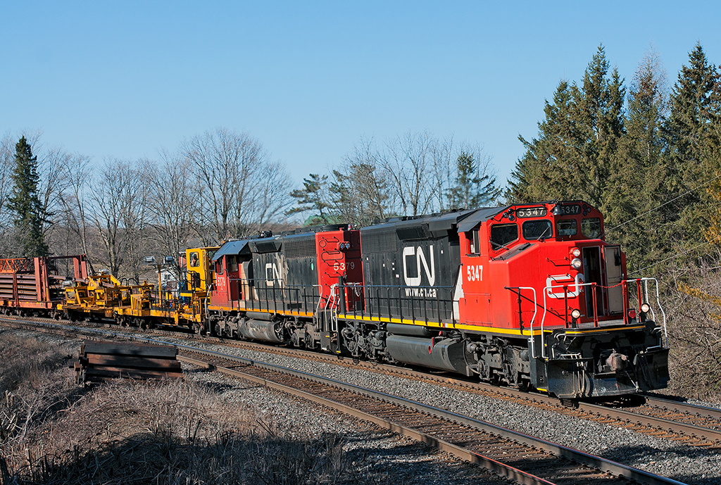 A pair of SD40 variants lead a ribbon rail train up the Bala, this work train was ordered at 0700 Mac Yard and began dumping rail in Richmond Hill. The train will head into the siding at Pine Orchard to allow VIA No.2, CN 108, CN 105 and CN 317 by before shoving out and continuing dumping rail at Mile 31.