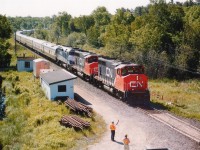 While out shooting CP in and around Parry Sound I noticed a light up on the CN for a northbound. Went over to Isabella St to wait around as I had no idea where this train might be. An old town "regular" can came up and started some chit-chat with me. The scanner crackled and I missed the transmission. A minute later, around the bend, past the station came CN and I just stepped back to watch. OMG!!! It is the American Orient Express!!!! Only the second time I had ever seen it, and again, right out of the morning sun. So I told the old guy I had to run. Hopped in the car and out onto Hwy 69 at a good clip. This train was really moving. I did not know where I would catch him so drove north until I saw the highway overpass up near Key River, some 80 KM up the road. Rather than getting mixed up in Sudbury, I elected to try for a shot here. Yelled over to a CN guy, and he told me the train "wasn't far off". I really had nowhere to wait but down by the car, as the bridge is not all that spacious (no sidewalk) and the truck traffic heavy. Figured I would hear something. I did, but almost too late. Ran like crazy, and just got to where I wanted to be with, seriously, not a second to spare. Looked down, saw the CN guy put his arm up to wave, and snapped the shot. I could have waited another maybe one second but....this was a lot better than missing it. Again, right out of the sun, but ten times better than at Parry Sound. Grabbed a couple of "going shots" off the other side of the bridge and then headed to Sudbury. But he beat me by a long shot, I was stuck in traffic. This was the last time I ever got to see the AOE. It was in business as luxury rail travel, beginning in 1989, but never really took off and became part of "Grandlux Express" and went bankrupt. August 28, 2008 it was all over. Equipment sold or scrapped.
The contract for power was with Amtrak, which is why you see AMTK 393 behind host CN 9672 and 9671.
