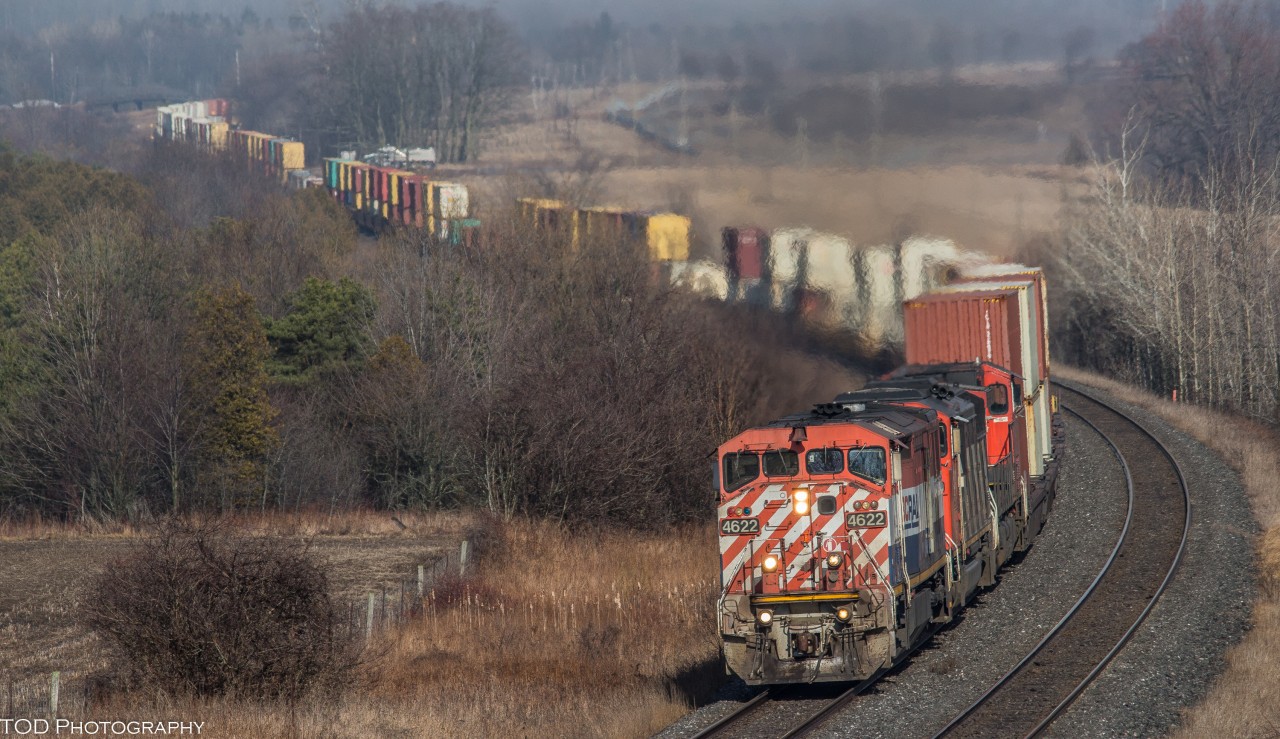 With a day full of rain and thundertorms, I didn't think I'd get a good shot of 149..  Despite the weather, I went out to shoot 149.

Only a few short minutes before 149 shows itself, the first speck of sunlight appears through the clouds. 149 rounds the bend at Newtonville with a clean BC Rail cowl on point. 

BCOL 4622, CN 5524, IC 2705
