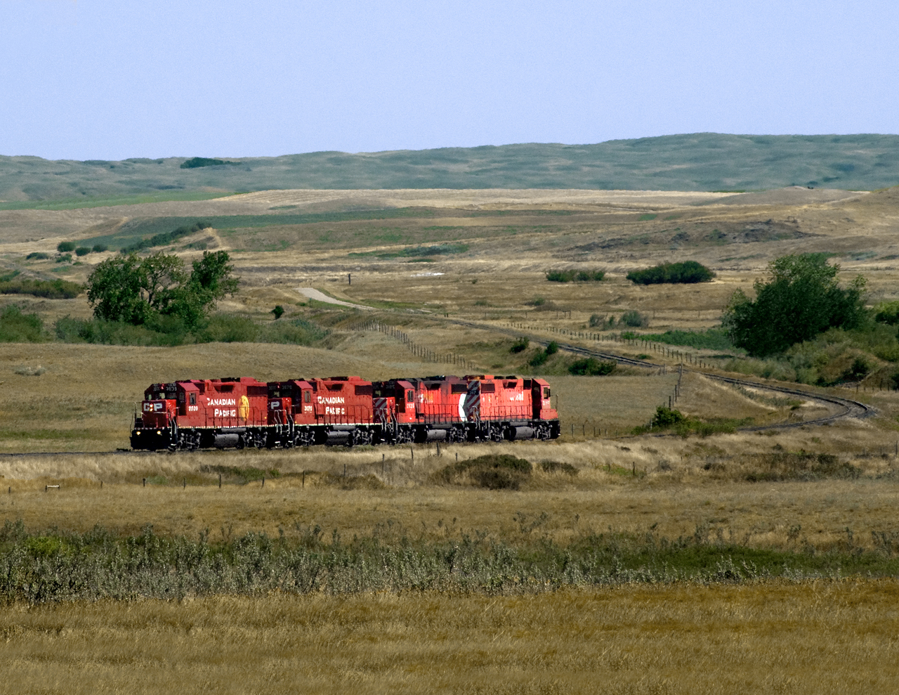 Light engines out of Moose Jaw bound for Mossbank to pick up grain loads off the Gravelbourg Subdivision cross the Cactus Hills