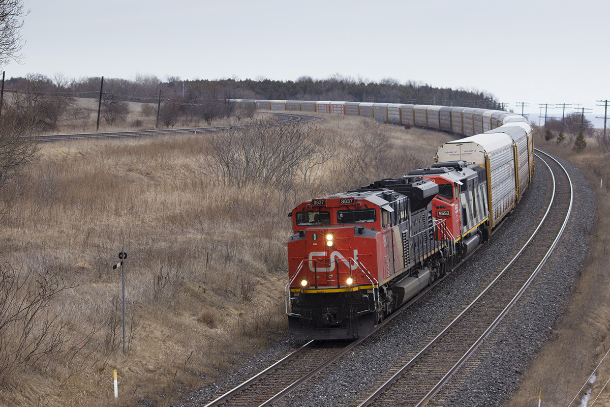 CN 371 coasts down through Lovekin with SD70M-2 8837 leading and SD60F 5553 right behind.