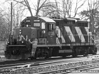 It's spring, and the crew in charge of CN 4136 have already gotten a jump on the day performing switching duties in the Brantford yard. Here, the conductor rides the engine to throw his next switch. Of note...4136 had served previously as the yard engine in Huntsville. You can see that photo here: 
<a href="http://www.railpictures.ca/?attachment_id=21044"> http://www.railpictures.ca/?attachment_id=21044