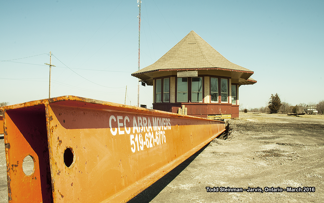 WHO ARE YOU GONNA CALL?  Driving through the day before, it was a surprise to see such activity at the Jarvis train station. Originally built around 1907, it replaced an earlier two storey structure that was built on the opposite side of the tracks. What made it unique, was not one, but two operators bays at the front and back. It was considered a 'union' station, because the two lines that eventually became part of the CNR network, were in fact built by the Great Western Railway (Cayuga Sub. - also referred to the Air Line) and the Hamilton & Northwestern Railway (Hagersville Sub). 

The last of the rails - the Cayuga Subdivision - was eventually abandoned and then subsequently torn up around 1996....and no train stopped at it's platforms since, well, I don't know when other than to say years before! It's uniqueness always greeted passengers from the front on the Cayuga Sub., and also from the back on the Hagersville Sub. And, as a young railfanner who is always intrigued by the architecture of these buildings, it was always a treat to see the station as we arrived in Jarvis on our way to Port Dover, Simcoe, etc.

When CN was done with the building, it housed a couple of businesses. First, there was the "Neat Little Bookstore"...and the last owners was Michaud Fine Woodworking. However, due to the huge successes of Michaud's, they required bigger space to manufacture and showcase their handmade wooden games. Therefore putting the half-renovated station up for sale. Whats in store next? The station obviously is on the move, and if anyone has information as to where please pass it on! A Tim Hortons will soon occupy what will have to be termed as the 'former station site', thus ending over 100 years of railroad history in the town of Jarvis.