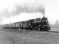 Canadian National Railway train 173, behind J-4-e 5126 and with a consist of four cars in tow, has just left Guelph and is shown running beside Edinburgh Road in 1958.<br><br>CNR 5126, a 4-6-2 "Pacific" built by MLW in 1920 as part of CN's J-4-e class, was scrapped two years later in February 1960.