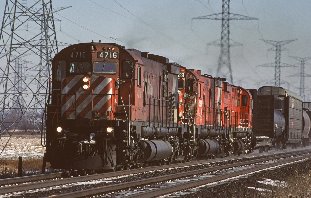 CPR M-636 4716 leads a trio of six-axle MLWs westbound on the Galt Sub approaching 5th Line on the eastern edge of Milton.
