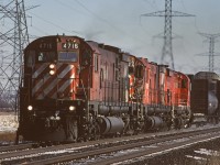 CPR M-636 4716 leads a trio of six-axle MLWs westbound on the Galt Sub approaching 5th Line on the eastern edge of Milton.