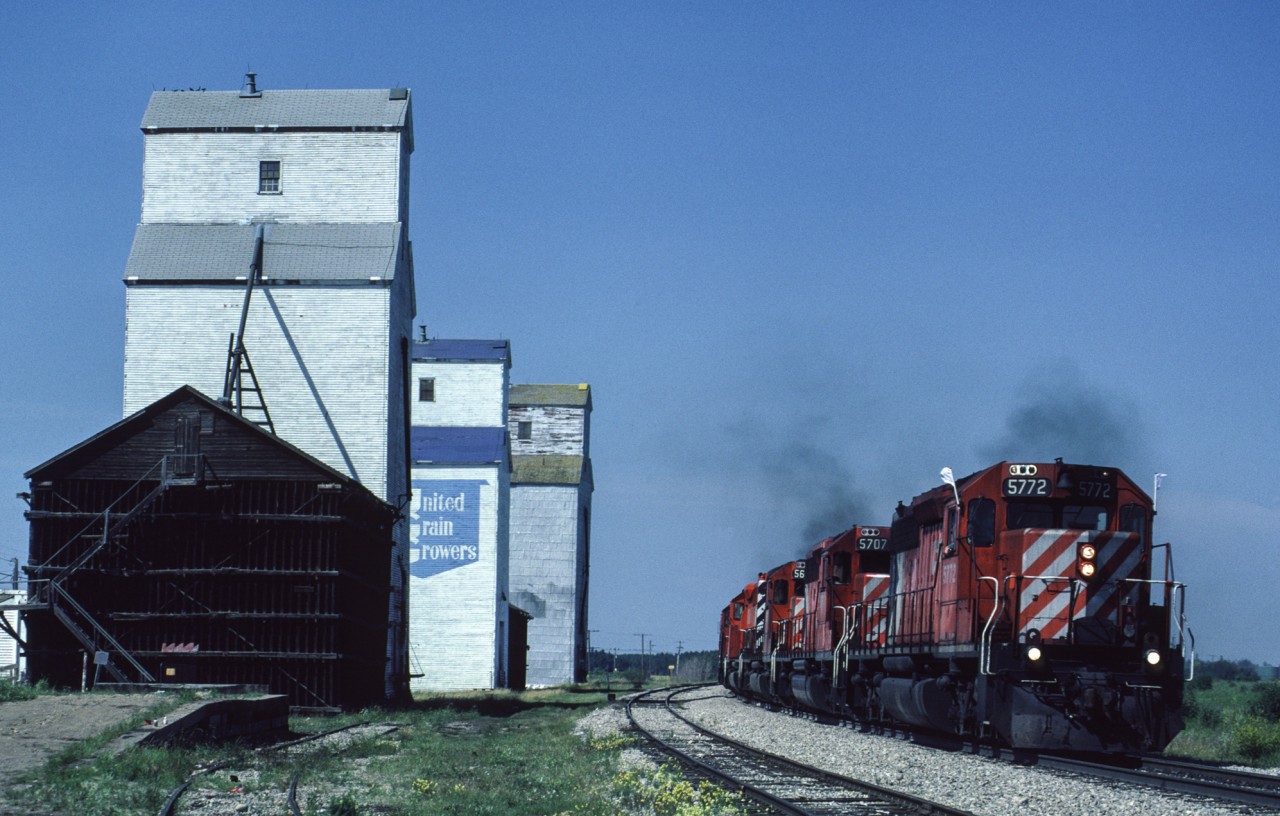 Five SD40-2s leads a southbound train past the row of grain elevators at Nisku, Alberta.