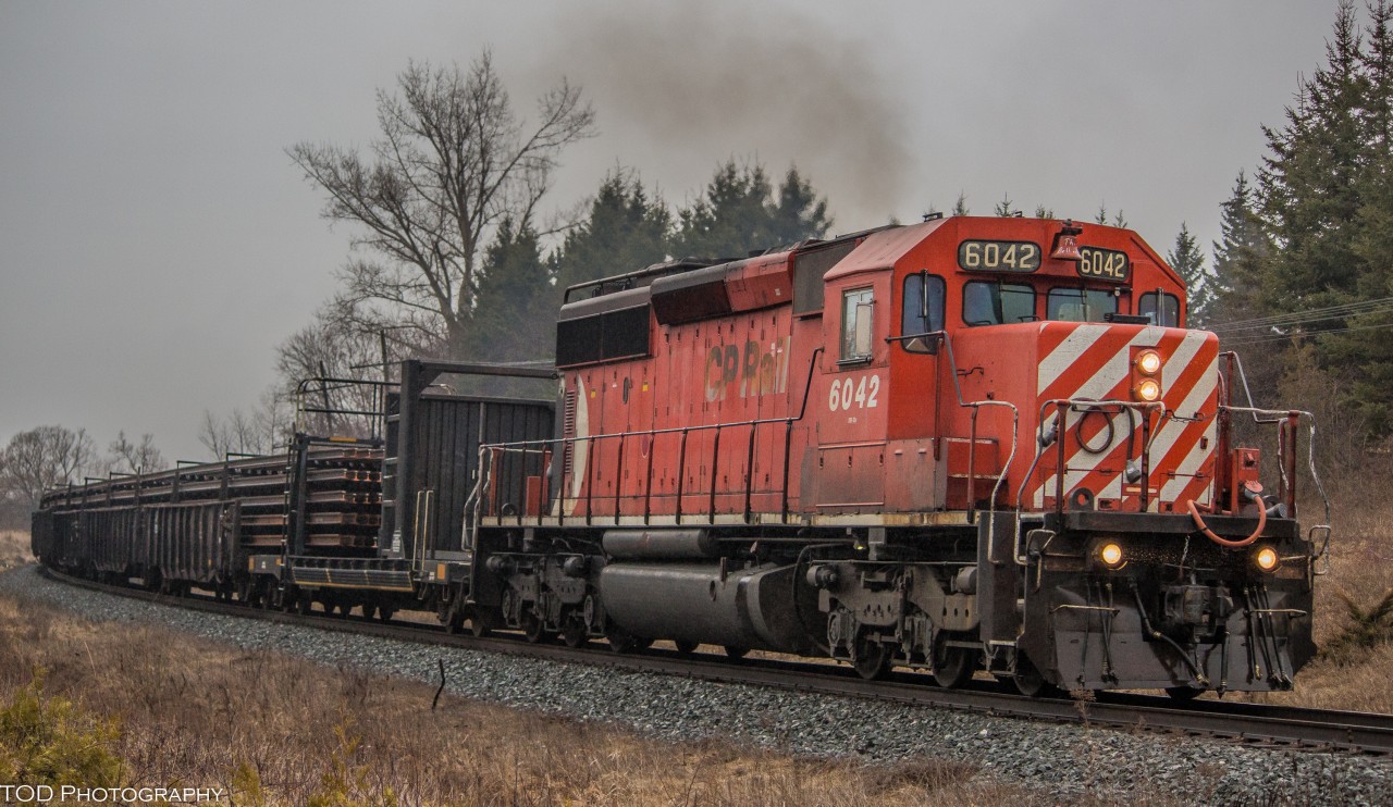 On a cloudy and rainy day, CP 6042 leads an Eastbound Rail train desitned for Montreal.