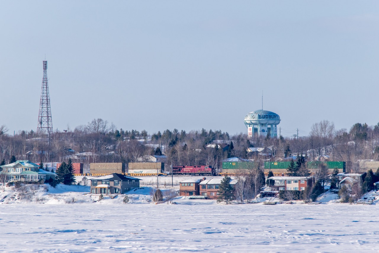 CP 8793 acts as mid train DP on an eastbound stack train under Sudbury's iconic water tower (which is still for sale). Photo taken looking north from Laurentian Bay on the south shore of Lake Ramsey.