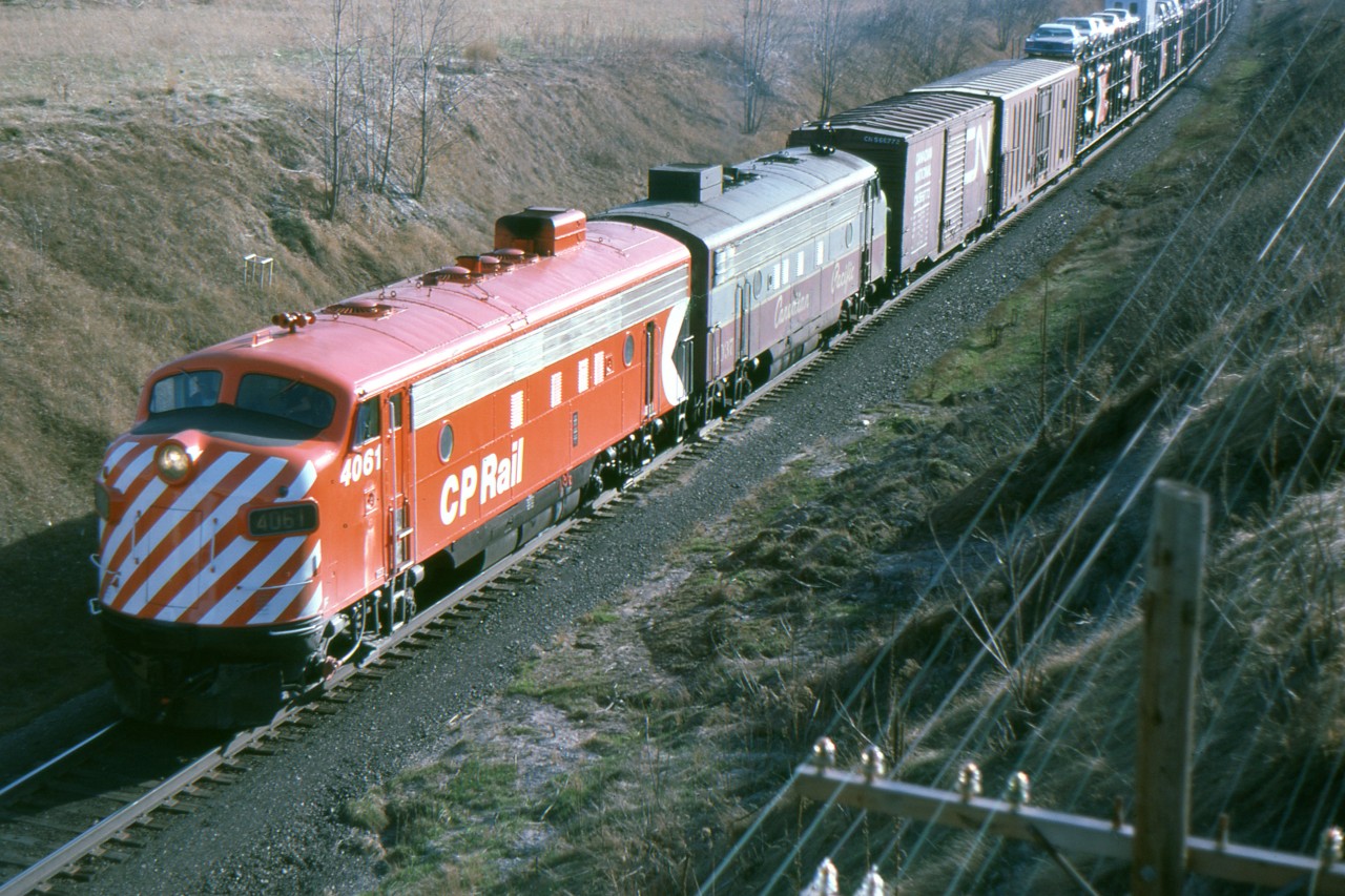 Freshly painted CP 4061 leads the last FP-7 in maroon and grey on an eastbound near Newtonville Ontario Apr. 17/77