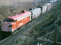 Freshly painted CP 4061 leads the last FP-7 in maroon and grey on an eastbound near Newtonville Ontario Apr. 17/77
