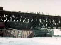 I am throwing this photo out to the viewers of RP in hopes that someone can fill me in on just what this scene was all about. My notes, after now 38 years, have been lost, as well as my recollection of the incident. I believe it was an eastbound Conrail (PC) that derailed. But not sure. Never did see the power. All I got to see was this mess below the Grand River bridge at Cayuga, piled up in the ice. After much looking around, there was really no way to photograph this but go back from where I was and drive up the east side of the river to what was Townline Road E., and walk. It was bitter cold with a strong wind blowing from the NorthWest, and the snow was about a foot deep. I guessed I walked a half mile. Right up the middle of a frozen river. And I noticed I was the only one that did. So came away with several pictures similar to this one. Can anyone shed some light on this wreck? THANKS!