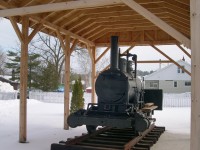 This 0-4-0 was built as a steam dummy by Baldwin in
1879 for the Hamilton & Dundas Street Railway. It ended up working
for the Beck lumber Co. in Penetanguishine. In the Early 2000's it
sat outside at the museum with a carbody covering most of the
engine. At the time of this photo it had been cosmetically restored
and an enclosure was being built. It is now fully walled in.