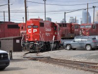 CP4451 (EMD GP-38-2) idles into the siding to pass thru locked gates to the pick up some tank cars, in alyth Yard , Calgary CP 9509 and 8577 (GE AC44CW) awaiting orders in the back ground.
