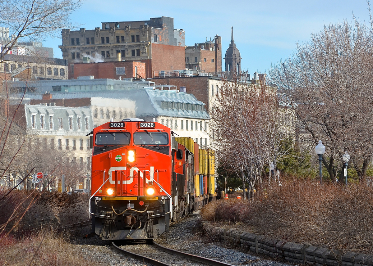 Crawling through old Montreal. All trains on CN's Wharf spur are limited to 10 mph, and even one of CN's hottest intermodal trains (Montreal-Chicago intermodal train CN 149) is not exempt from this restriction as it crawls through old Montreal with fairly new ET44AC CN 3026 leading two more GE products (CN 2861 & BCOL 4621).
