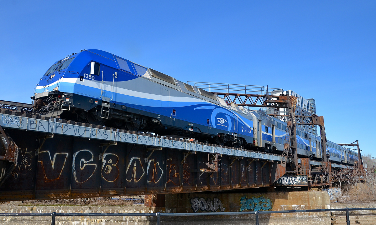The mid-day departure for Mont-Saint-Hilaire. AMT 1350 leads AMT 808 over the Lachine canal. This is the 1230 departure from Montreal's Central station for Mont-Saint-Hilaire on the south shore.