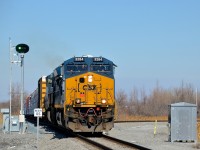 <b>Not a signal, but a switch point indicator.</b> CN 327 with fairly new unit CSXT 3284 leading and CSXT 5101 trailing is passing a switch point indicator which indicates over the radio whether the switch is lined for the main or the diverging route. The track at right is the south switch to CSXT's new intermodal terminal in Valleyfield.
