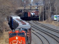 <b>Through a short tunnel and an s-curve.</b> A much shorter than usual CN 401 from Joffre has a single ES44DC (CN 2299) snaking through Montreal West on the transfer track of CN's Montreal sub.