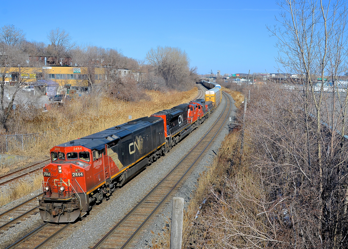 Cowl leader on CN 401. CN 401 has a cowl leader (CN 2444) along with CN 8002, CN 7275 & CN 218 as it passes through Montreal West on a gorgeous and warm afternoon.