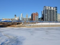 <b>Blue and white.</b> The blue sky meets the white, ice-covered Peel Basin as AMT 809 with a matching consist in the grey, blue and white paint scheme heads towards Central Station in downtown Montreal.