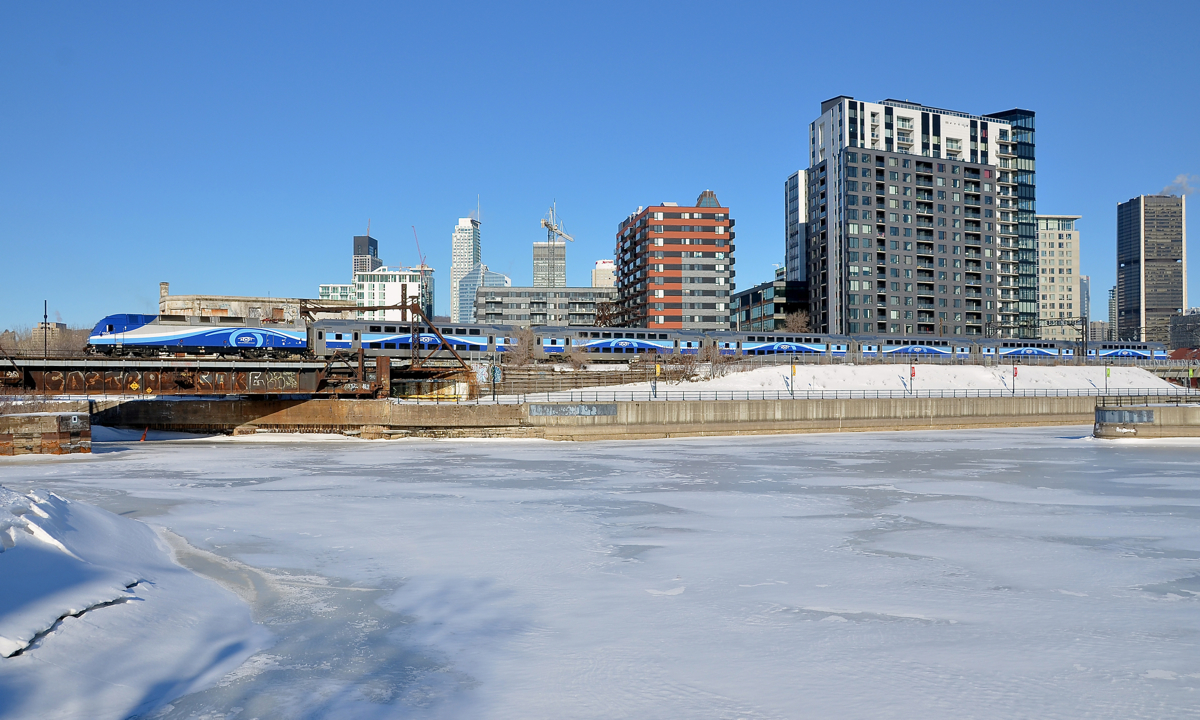 Blue and white. The blue sky meets the white, ice-covered Peel Basin as AMT 809 with a matching consist in the grey, blue and white paint scheme heads towards Central Station in downtown Montreal.