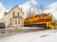 RLHH 496 makes their way past # 12 Port Street in downtown Brantford with QGRY 2301 leading the way.  The crew took this crossing extra slow as it was under several inches of water at the time.